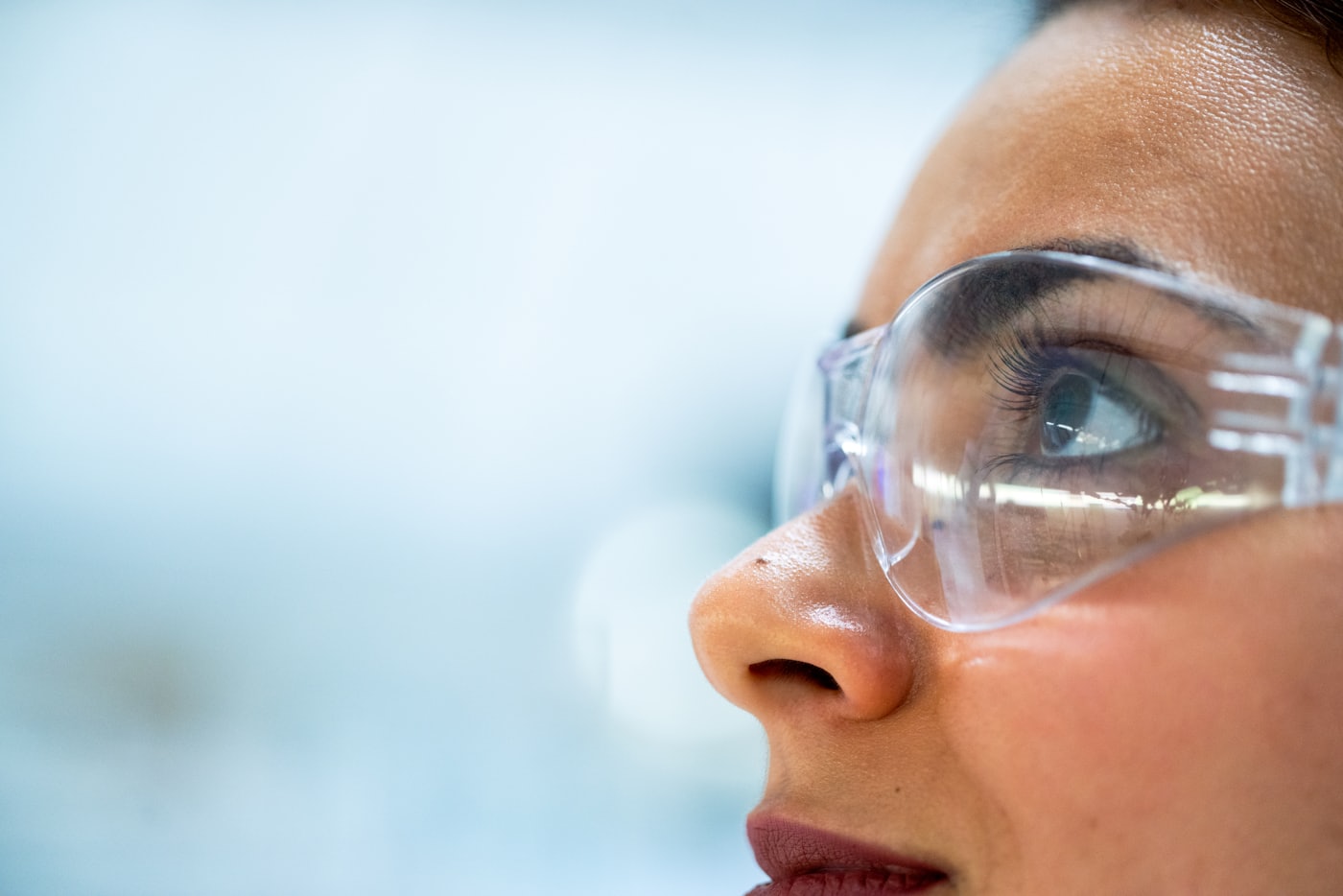 Clinical research scientist in a laboratory wearing protective eyewear